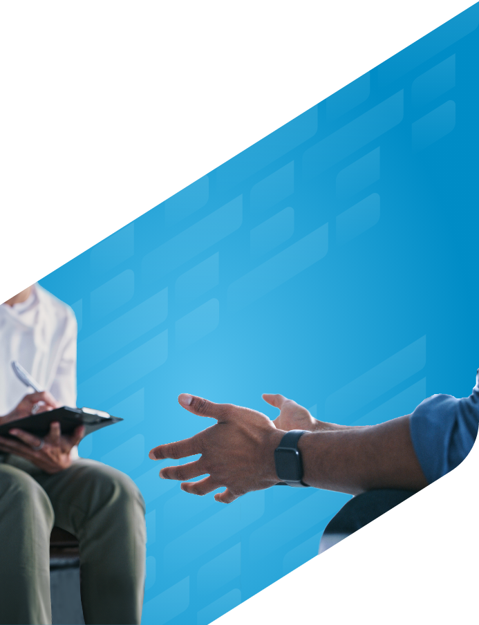 Close-up photo on patient hands while talking with healthcare provider taking notes on a clipboard